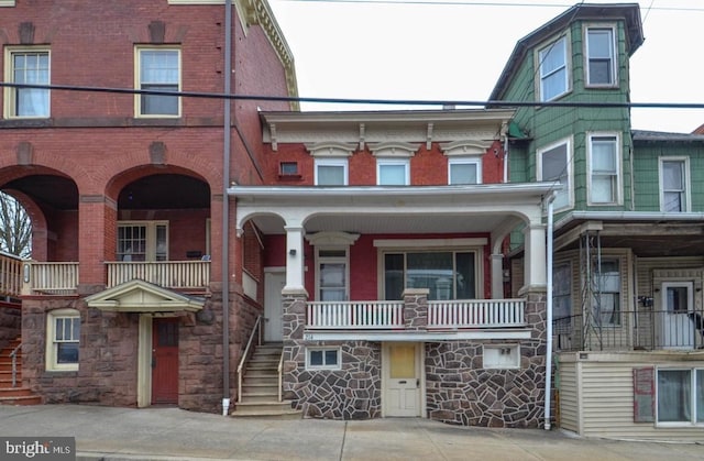 214 E Main St, Schuylkill Haven, PA 17972 - view of property featuring brick siding, stairway, and covered porch