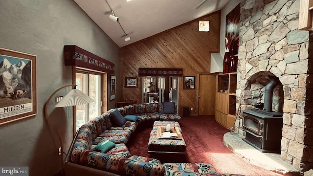 33 Morgan Hollow Way, Landenberg, PA 19350 - living area featuring high vaulted ceiling, a wood stove, wood walls, and carpet