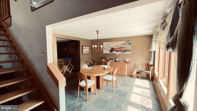 33 Morgan Hollow Way, Landenberg, PA 19350 - dining room featuring stairs, a textured ceiling, a textured wall, a chandelier, and stone finish floors