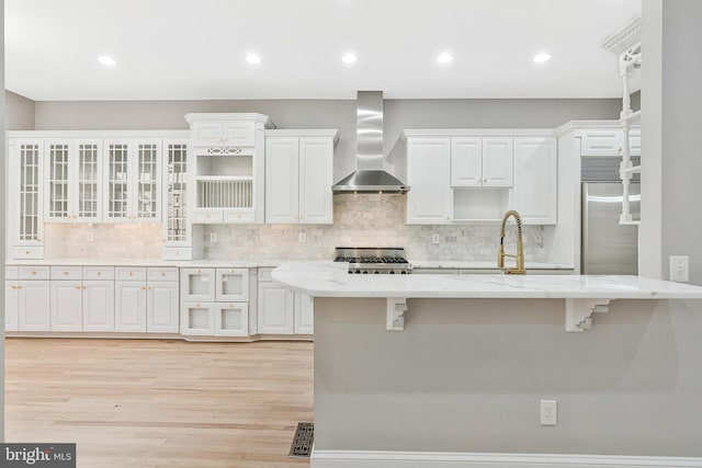 1473 Evans Farm Dr, Mclean, VA 22101 - kitchen featuring wall chimney range hood, stainless steel built in refrigerator, light wood finished floors, white cabinets, and tasteful backsplash