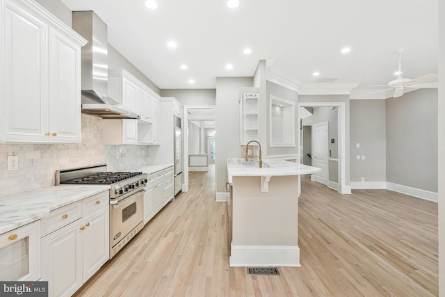 1473 Evans Farm Dr, Mclean, VA 22101 - kitchen featuring high quality appliances, wall chimney range hood, white cabinetry, tasteful backsplash, and a peninsula
