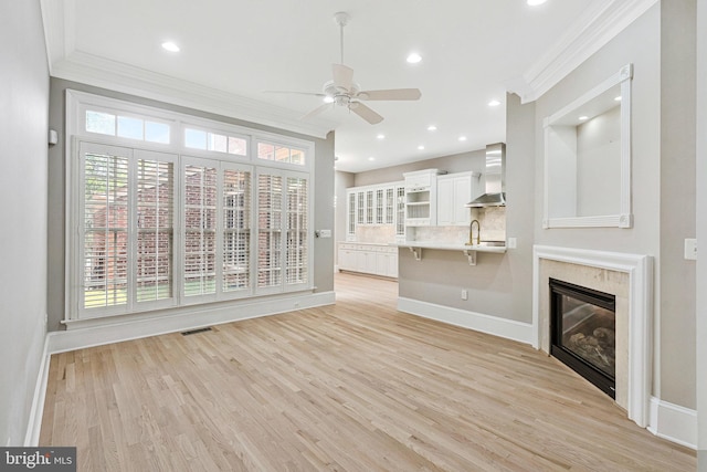 1473 Evans Farm Dr, Mclean, VA 22101 - unfurnished living room featuring ornamental molding, ceiling fan, baseboards, light wood-style floors, and a sink