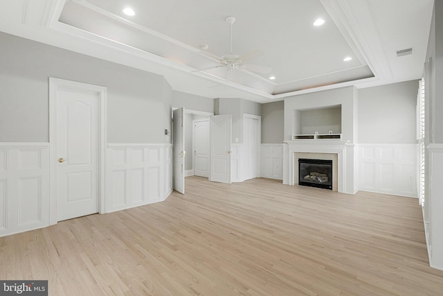 1473 Evans Farm Dr, Mclean, VA 22101 - unfurnished living room featuring a decorative wall, a ceiling fan, a raised ceiling, light wood-style flooring, and wainscoting