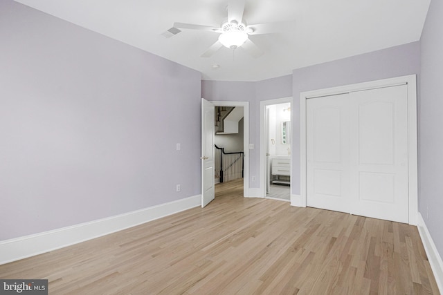 1473 Evans Farm Dr, Mclean, VA 22101 - unfurnished bedroom featuring light wood-type flooring, baseboards, a closet, a ceiling fan, and connected bathroom