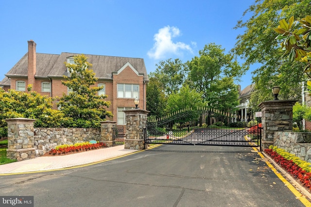 1473 Evans Farm Dr, Mclean, VA 22101 - view of asphalt street with a gate, curbs, a gated entry, and street lights