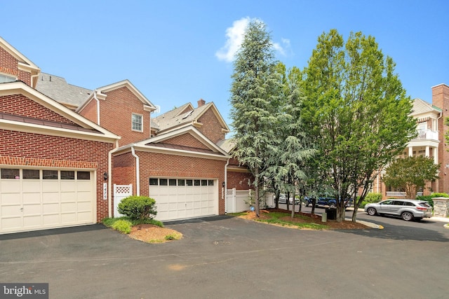 1473 Evans Farm Dr, Mclean, VA 22101 - view of front facade with brick siding, driveway, and a garage