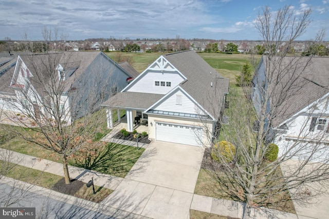30 Amandas Teal Dr, Bridgeville, DE 19933 - view of front facade with a standing seam roof, concrete driveway, metal roof, covered porch, and a garage