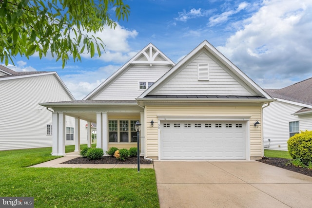 30 Amandas Teal Dr, Bridgeville, DE 19933 - view of front of home with driveway, a front yard, a standing seam roof, an attached garage, and metal roof