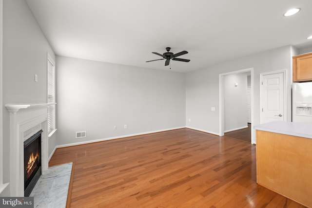30 Amandas Teal Dr, Bridgeville, DE 19933 - unfurnished living room featuring a ceiling fan, a fireplace with flush hearth, wood finished floors, recessed lighting, and baseboards