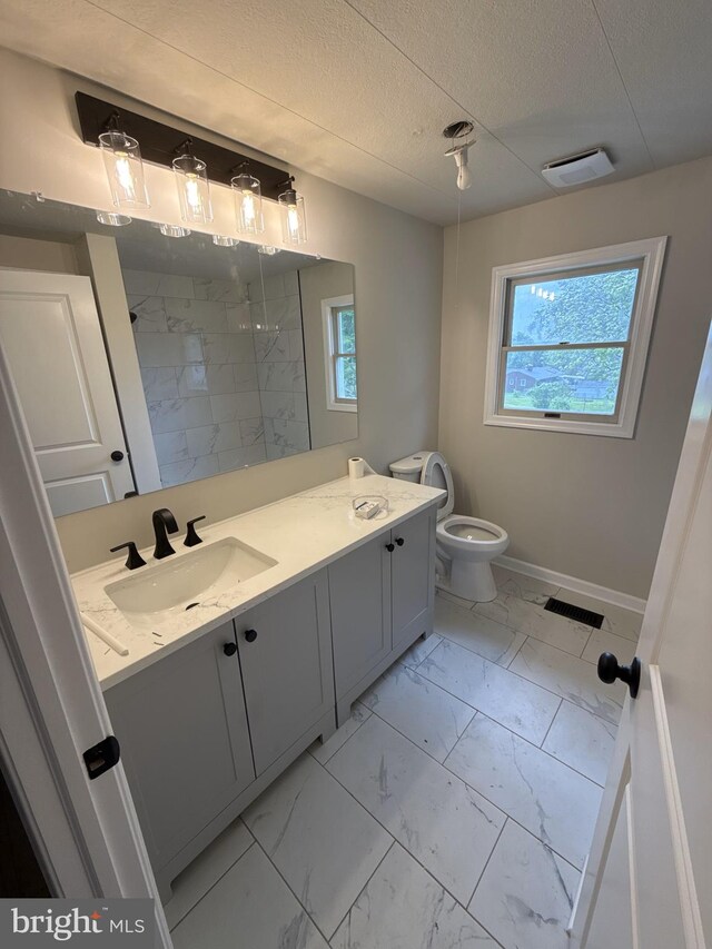 2205 Roth Rd, Edgewood, MD 21040 - bathroom featuring marble finish floors, plenty of natural light, tiled shower, vanity, and a textured ceiling