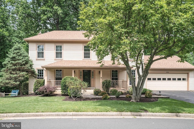 5926 Clermont Landing Ct, Burke, VA 22015 - colonial house featuring driveway, an attached garage, covered porch, and a front lawn