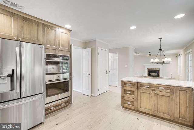 5926 Clermont Landing Ct, Burke, VA 22015 - kitchen with appliances with stainless steel finishes, ornamental molding, light wood-type flooring, recessed lighting, and a brick fireplace