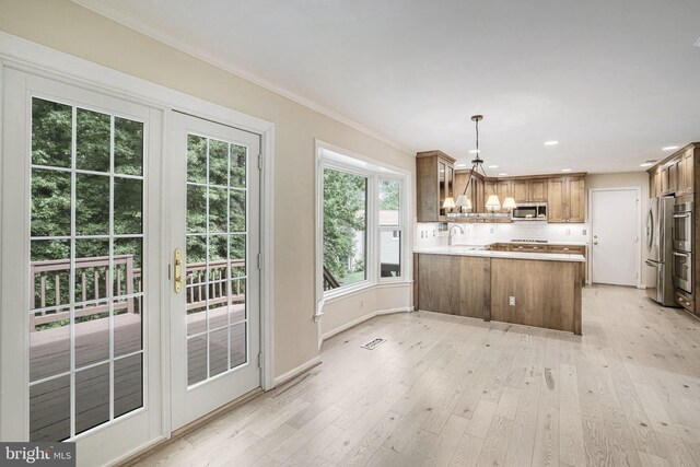 5926 Clermont Landing Ct, Burke, VA 22015 - kitchen with stainless steel appliances, a peninsula, brown cabinetry, healthy amount of natural light, and recessed lighting
