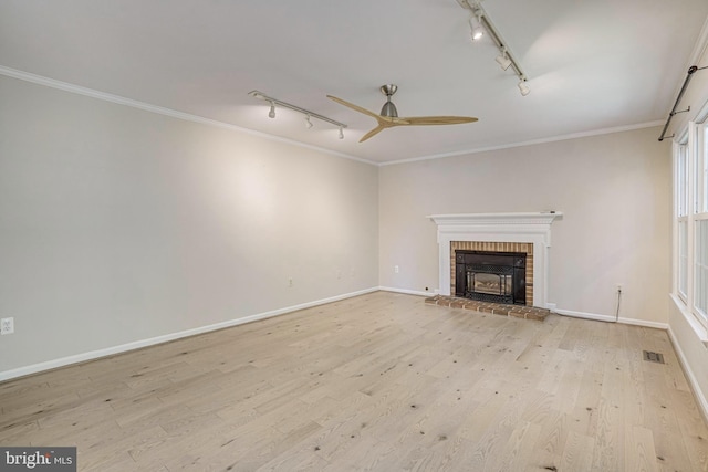 5926 Clermont Landing Ct, Burke, VA 22015 - unfurnished living room featuring track lighting, ornamental molding, light wood finished floors, a ceiling fan, and a fireplace