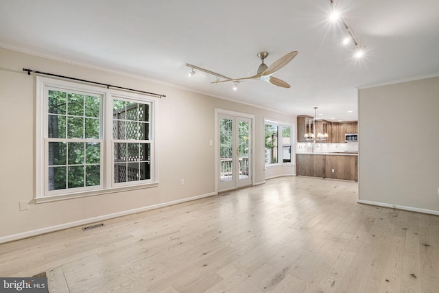 5926 Clermont Landing Ct, Burke, VA 22015 - unfurnished living room featuring rail lighting, ornamental molding, a chandelier, light wood-style flooring, and ceiling fan