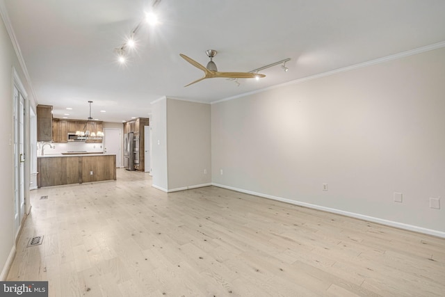 5926 Clermont Landing Ct, Burke, VA 22015 - unfurnished living room with ornamental molding, track lighting, light wood-style flooring, a chandelier, and baseboards
