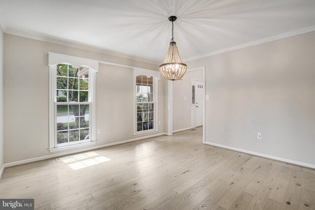 5926 Clermont Landing Ct, Burke, VA 22015 - spare room featuring a chandelier, crown molding, baseboards, and hardwood / wood-style flooring