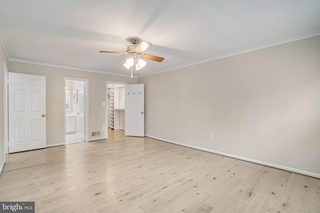 5926 Clermont Landing Ct, Burke, VA 22015 - unfurnished bedroom with light wood finished floors, ornamental molding, baseboards, ensuite bath, and a spacious closet