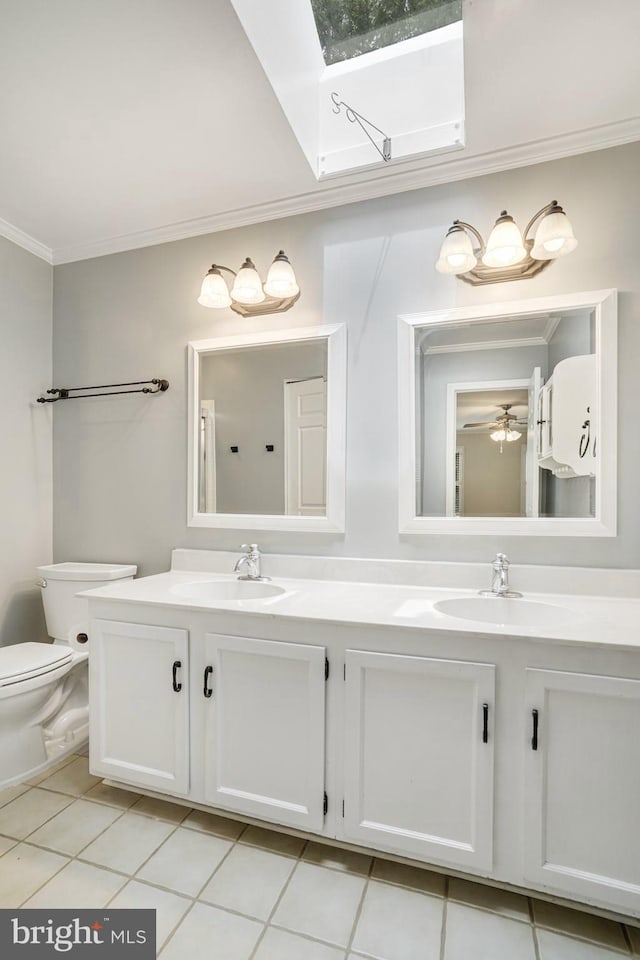 5926 Clermont Landing Ct, Burke, VA 22015 - bathroom with double vanity, a skylight, crown molding, toilet, and tile patterned flooring