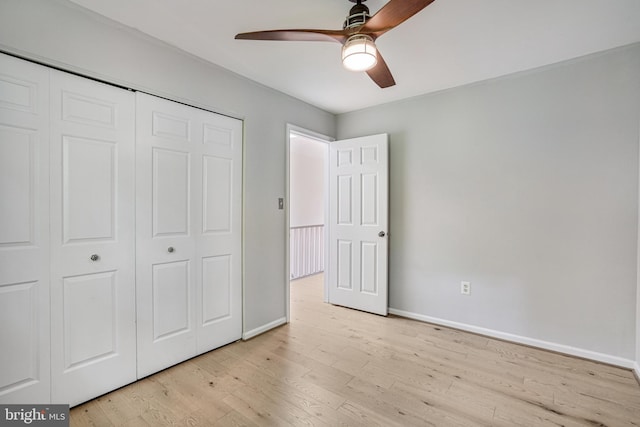 5926 Clermont Landing Ct, Burke, VA 22015 - unfurnished bedroom featuring a closet, baseboards, light wood finished floors, and ceiling fan