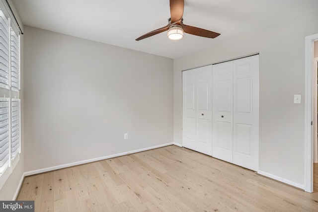 5926 Clermont Landing Ct, Burke, VA 22015 - unfurnished bedroom with wood finished floors, baseboards, a closet, and a ceiling fan