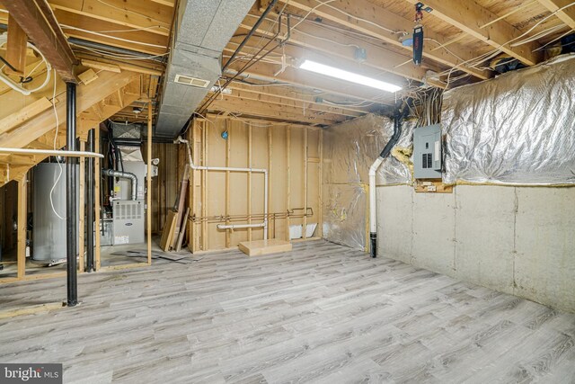 5926 Clermont Landing Ct, Burke, VA 22015 - unfinished basement featuring electric panel, wood finished floors, and heating unit