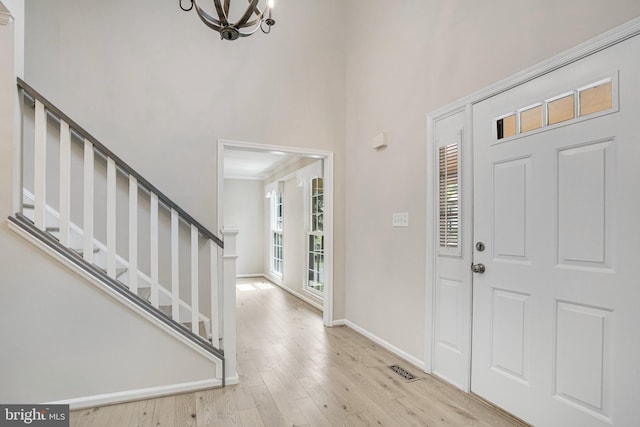 5926 Clermont Landing Ct, Burke, VA 22015 - foyer with plenty of natural light, a chandelier, stairway, wood finished floors, and a towering ceiling