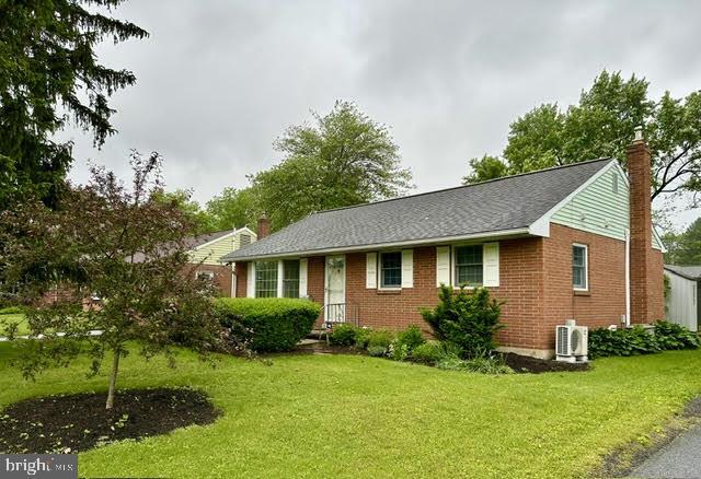 440 N Mount Joy St, Elizabethtown, PA 17022 - view of front of house featuring a chimney, a front lawn, and brick siding