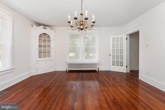 2806 Northumberland Hwy, Lottsburg, VA 22511 - unfurnished dining area with radiator, a chandelier, wood finished floors, and baseboards