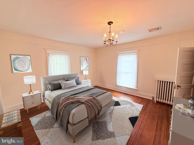 2806 Northumberland Hwy, Lottsburg, VA 22511 - bedroom featuring a chandelier, baseboards, wood finished floors, and radiator