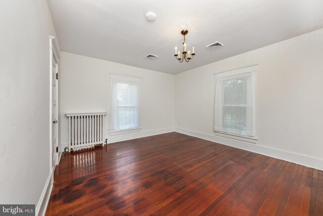 2806 Northumberland Hwy, Lottsburg, VA 22511 - empty room featuring radiator, a chandelier, hardwood / wood-style flooring, and baseboards