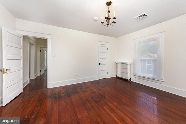 2806 Northumberland Hwy, Lottsburg, VA 22511 - empty room with radiator, a chandelier, wood finished floors, and baseboards
