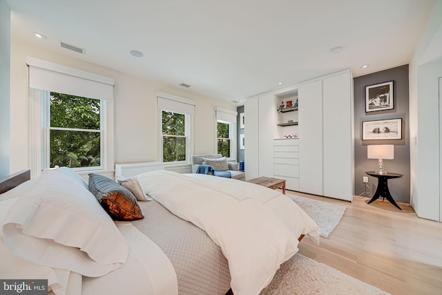 1448 Corcoran St NW, Washington, DC 20009 - bedroom featuring multiple windows, light wood-style floors, and recessed lighting