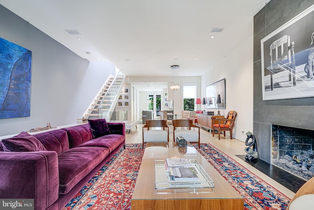 1448 Corcoran St NW, Washington, DC 20009 - living area with a chandelier, stairs, a fireplace, and wood finished floors