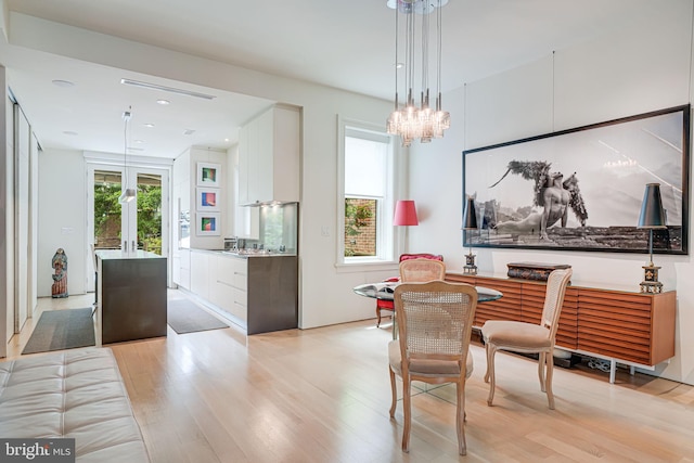 1448 Corcoran St NW, Washington, DC 20009 - dining space featuring light wood-style flooring and a chandelier