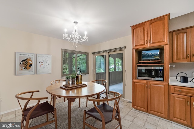 20138 Wynnfield Dr, Germantown, MD 20874 - dining room featuring light tile patterned flooring, a chandelier, and baseboards