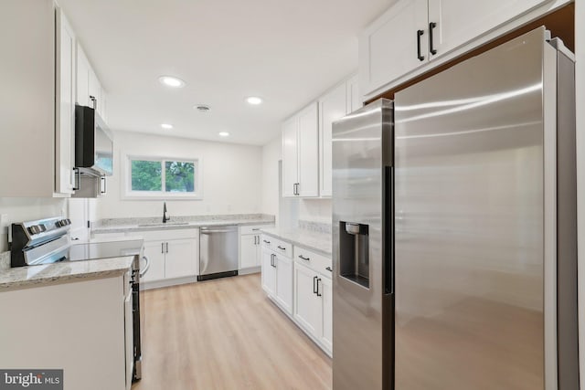 818 Dale Rd, Glen Burnie, MD 21060 - kitchen with stainless steel appliances, a sink, light wood-style floors, white cabinetry, and light stone counters