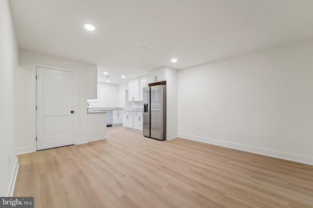 818 Dale Rd, Glen Burnie, MD 21060 - unfurnished living room with light wood-style flooring, baseboards, and recessed lighting