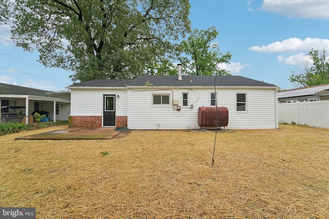 818 Dale Rd, Glen Burnie, MD 21060 - rear view of house featuring oil tank and a patio