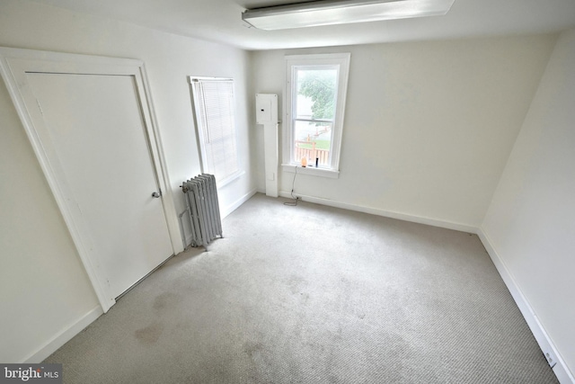 476 W Market St, York, PA 17401 - unfurnished bedroom featuring radiator heating unit, light carpet, and baseboards