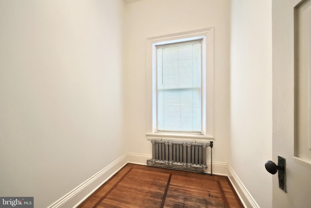 476 W Market St, York, PA 17401 - spare room with radiator heating unit, dark wood-style flooring, and baseboards