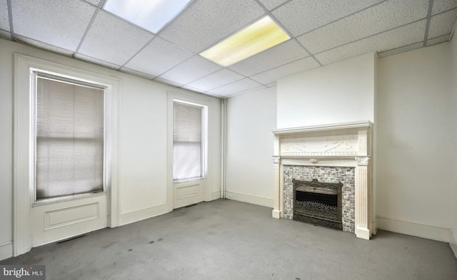 476 W Market St, York, PA 17401 - unfurnished living room featuring a drop ceiling, a tile fireplace, and baseboards