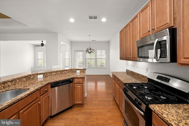54 Ruddy Duck Ln, Bridgeville, DE 19933 - kitchen with appliances with stainless steel finishes, light wood-style flooring, a chandelier, healthy amount of natural light, and recessed lighting