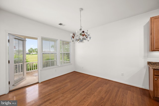 54 Ruddy Duck Ln, Bridgeville, DE 19933 - unfurnished dining area featuring a chandelier, wood finished floors, and baseboards