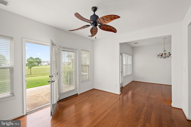 54 Ruddy Duck Ln, Bridgeville, DE 19933 - empty room with plenty of natural light, wood finished floors, and a ceiling fan