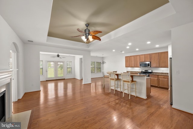 54 Ruddy Duck Ln, Bridgeville, DE 19933 - kitchen featuring a tray ceiling, stainless steel appliances, a ceiling fan, recessed lighting, and a kitchen bar