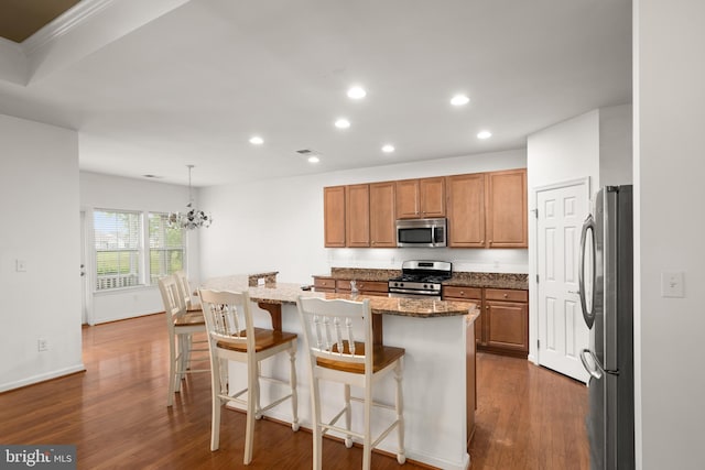 54 Ruddy Duck Ln, Bridgeville, DE 19933 - kitchen with stainless steel appliances, recessed lighting, brown cabinets, dark wood finished floors, and dark stone counters