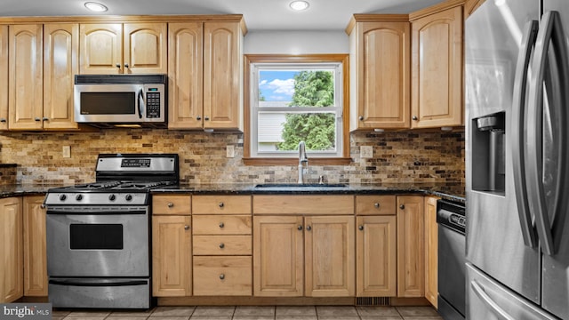 141 N Woodbine Ave, Langhorne, PA 19047 - kitchen featuring appliances with stainless steel finishes, a sink, light brown cabinets, dark stone countertops, and recessed lighting