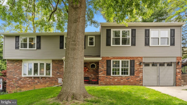 141 N Woodbine Ave, Langhorne, PA 19047 - view of front of property with brick siding, a front yard, and a garage
