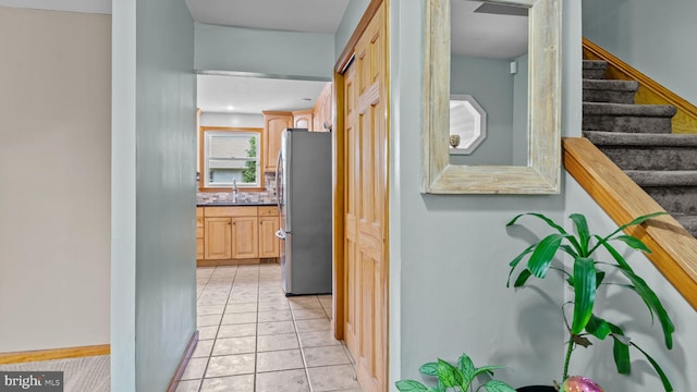 141 N Woodbine Ave, Langhorne, PA 19047 - hallway with a sink, stairs, light tile patterned floors, and baseboards